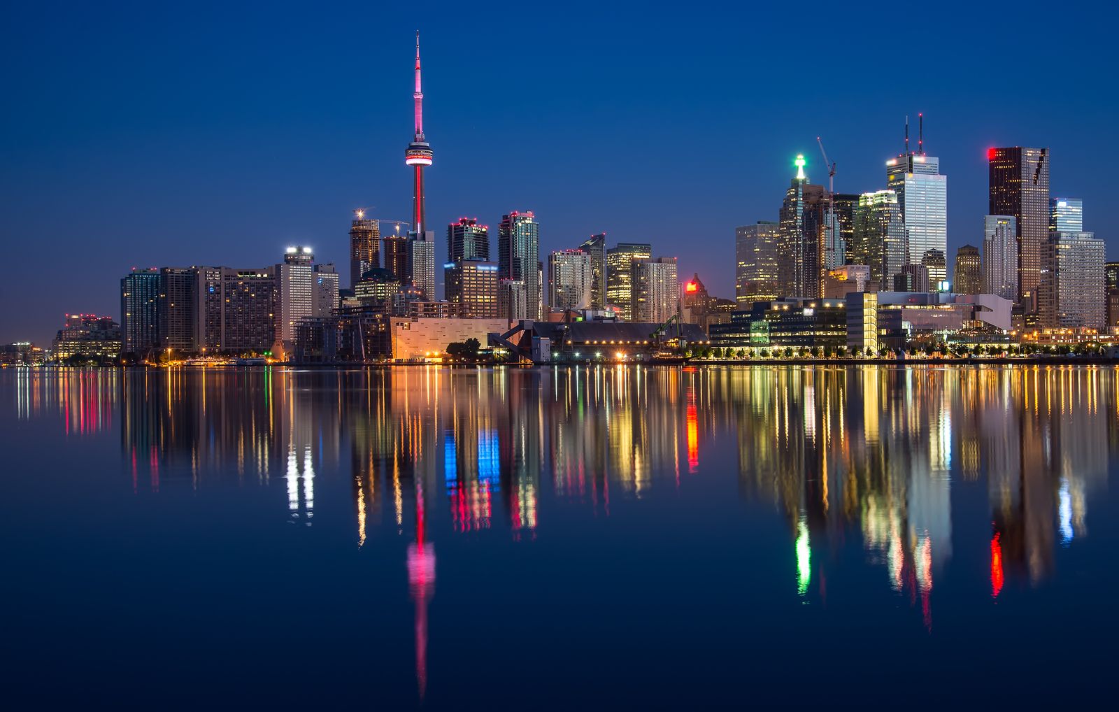 CN Tower rising above downtown Toronto with urban plaza in foreground